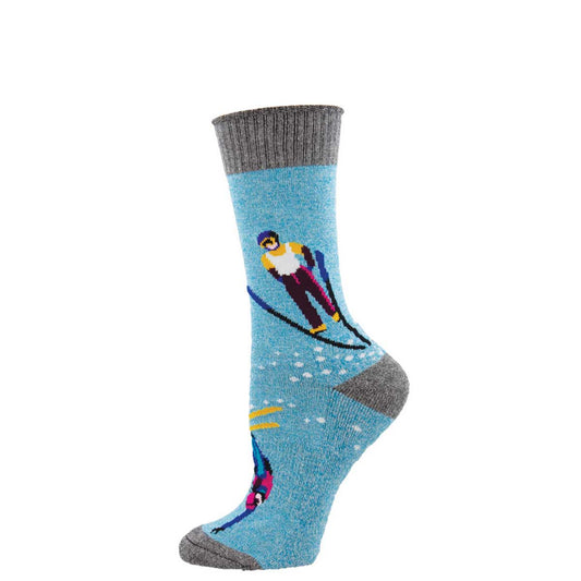 A pair of blue ski slope design socks with gray at the top and bottom and a character skiing in a snow environment depicted on the socks.