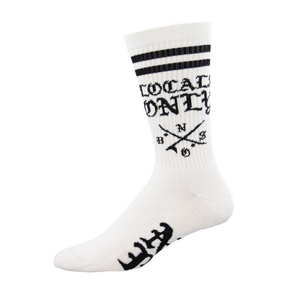 A pair of white crew socks with the text 'LOCALS ONLY' and the logo 'NO BS' printed in black on the calf area. The socks also feature two white horizontal stripes near the top and a graphic pattern near the ankle.