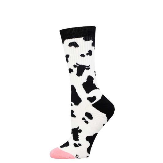 A pair of crew socks with a cow print design in black and white, with a small udderly pink toe.