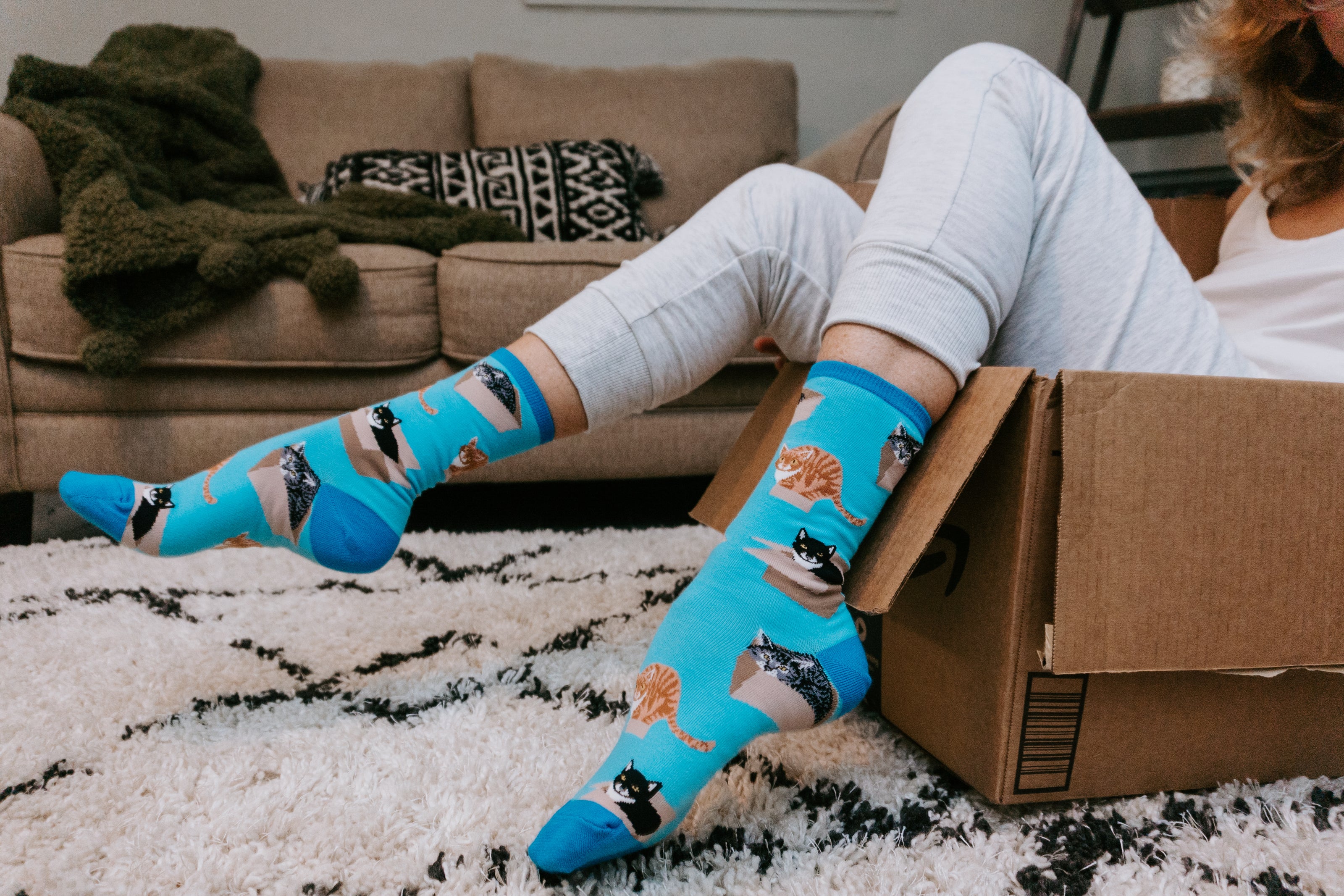 Close-up of cat in cardboard box design on women’s socks